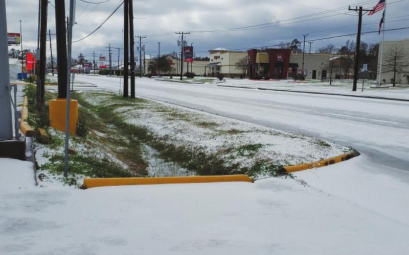 Few ventured out to brave the icy roads Monday as streets became treacherously slick. This view is looking south in the 1300 block of North Main.