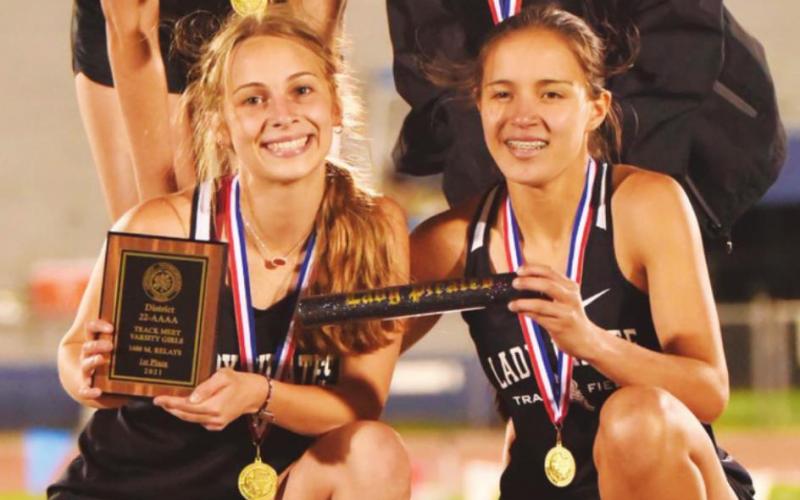 Mile Relay District champs-Lady Pirates Raegan Stephenson, Amelia Wright, Jana Baters and Sofia Rodriguez pose on the podium following their first place finish in the district track meet last week.