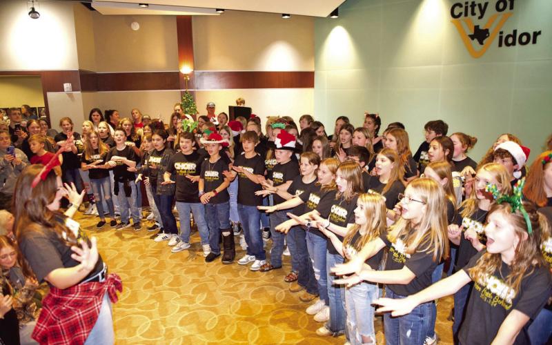 The Vidor Middle School 6th Grade Choir under the direction of Genevieve Brassard entertained a crowd Friday at Vidor City Hall at the Light Up City Hall portion of the 3-day Vidor Hometown Holidays event sponsored by the City of Vidor, Vidor Chamber of Commerce and Eastgate Church.