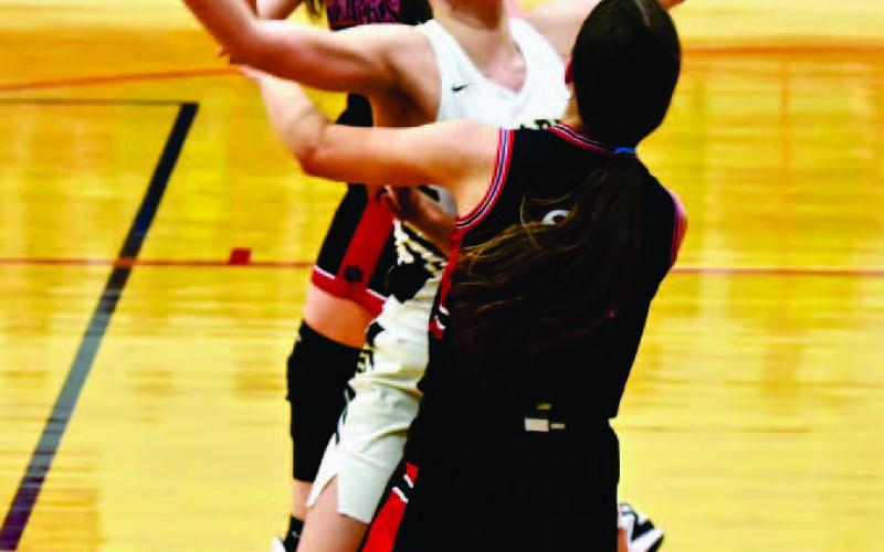 Raegan Stephenson blocks a Starks player in the Lady Pirates opening game in the Deweyville Tournament.