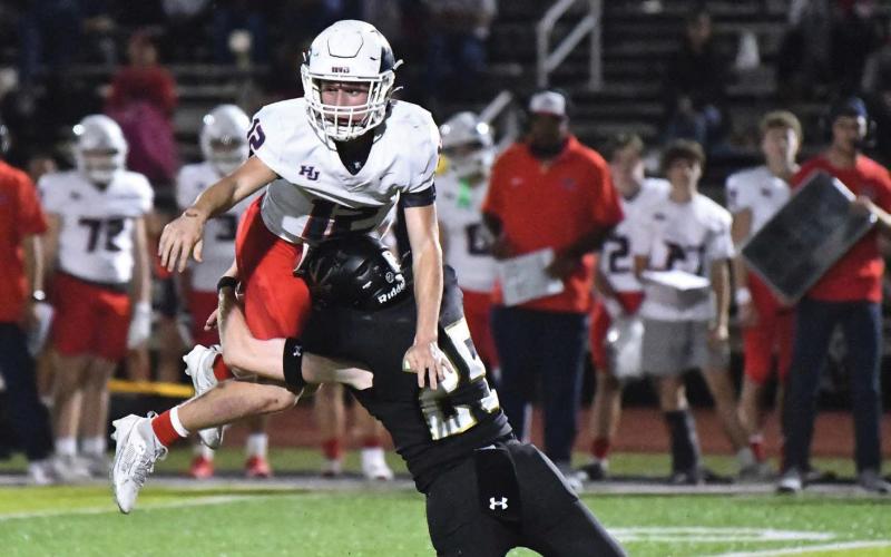 Hyrum Huish wraps up Hawk QB Ryan Samoff in the backfield to break up a pass attempt.