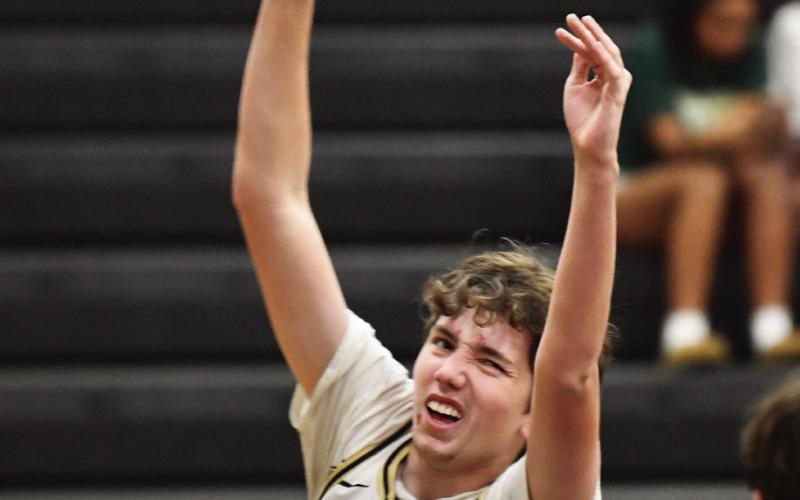 Jaxon Whittington makes a jump shot in the midst of Bear defenders.
