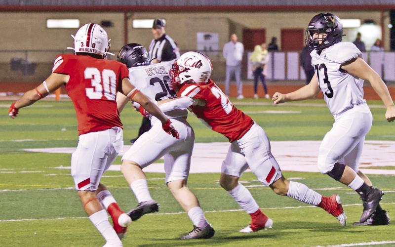 A pair of Wildcat defenders find it tough to tackle Pirate fullback Riley Marlow.