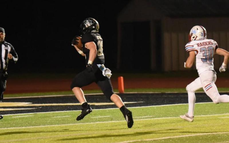 Photo by Randall Luker Layne Wilhelm won’t be caught as he makes a 33 yard run to tie the game 27 all against Lumberton Friday.