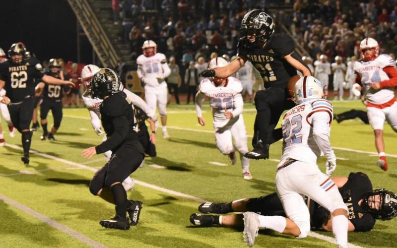 Photo by Randall Luker Pirate RB Austin Rodgers vaults over a teammate and the Raiders’ 10 yard line in red zone action Friday.