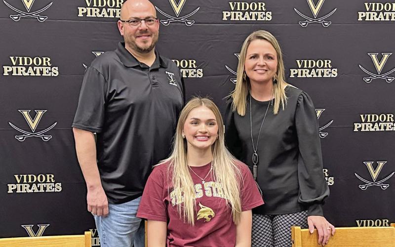 Lady Pirate high jumper Raegan Stephenson officially committed to Texas State in San Marcos last week. As a Freshman, Stephenson won a silver medal in the 4A girls high jump at the state meet and last year, she won the gold medal with a jump of 5 feet, seven inches. Stephenson is pictured with her coaches Darin Fletcher and Tracy Maines.