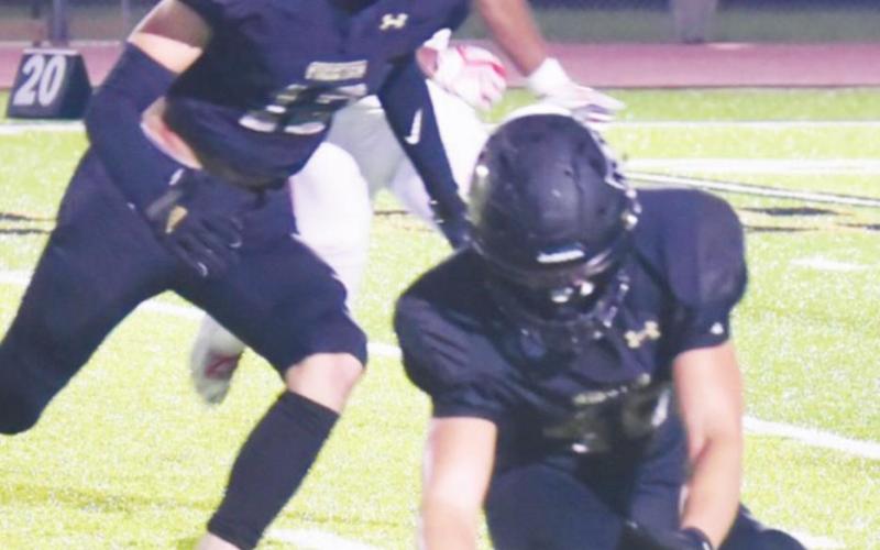 Dayton Whitmire, left, #12, blocked a Brazosport punt that was covered by Tanner Teems, #40.