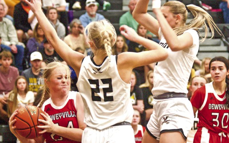 Frustration is evident on the face of a Deweyville Lady Pirate as Jaelyn Justice and Raegan Stephenson block a pass attemp