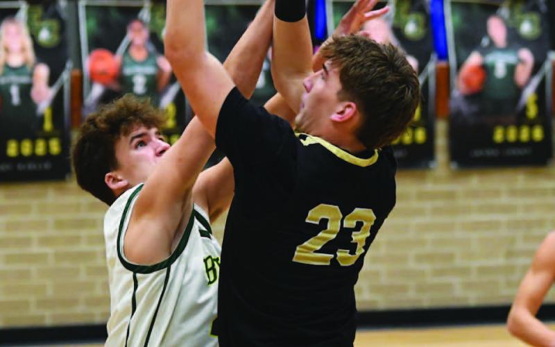 Caden Beavers shoots over an East Chambers defender.