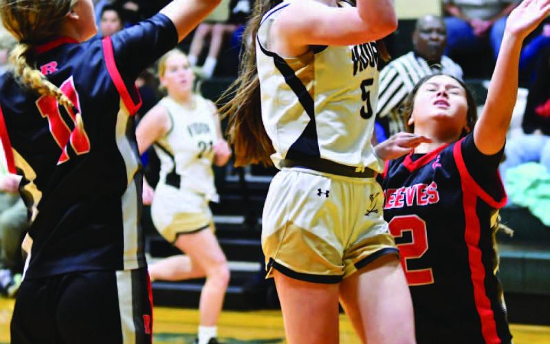 Hadlie Jackson gets off a shot between two Raider defenders.