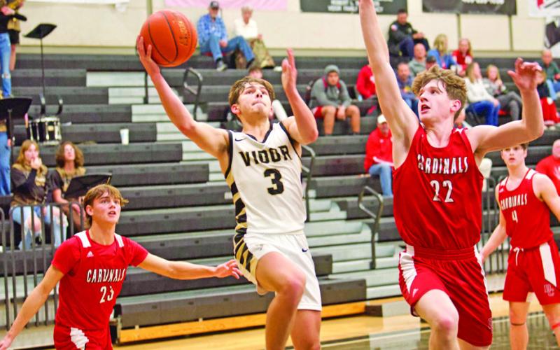 Finding a seam Jose Guerrero-Evans shoots between two BC defenders Tuesday in Vidor.