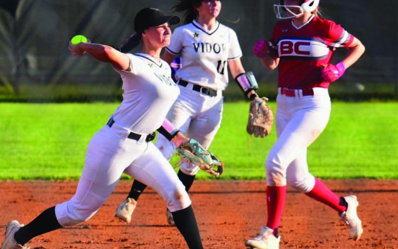 Lady Pirate third baseman Andreya Garrett tags the bag after a throw from the outfield and makes the throw to first in the Lady Pirates 3-0 loss to Bridge City Tuesday. Eryn Barrazza, #11, backs up the play. Photo by Randall Luker