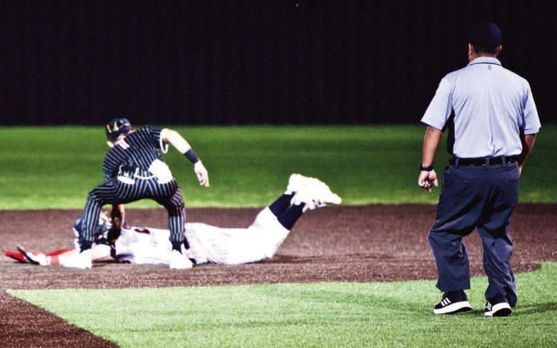 Pirate second baseman Daigan Venable tags a Hawk runner out in Saturday’s bi-district game in Bridge City.