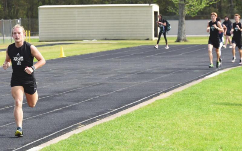 Pirate speedster Kai Reed leads the pack in the 1600M run at the LCM meet Friday, Reed placed first followed by teammates Bowman and Andrew Fawcett for a 1-2-3 finish for the Pirates.