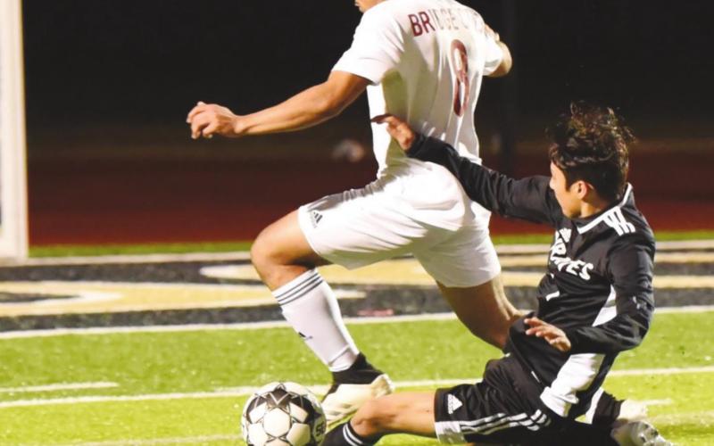 Samuel Estupinan slide tackles a BC Cardinal at home Friday.