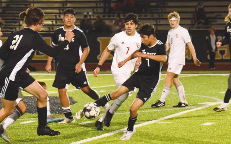 Pirates Keegan Day #5, Samuel Estupinan #7, Aaron Guevara #23, and Cesar Zapata #21 work the ball near mid-field against Bridge City.