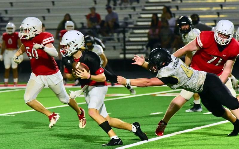 Peyton Ragan kept a firm grip on a BC runner Thursday and held on to tackle him for a loss of yardage on the play. Photo by Randall Luker
