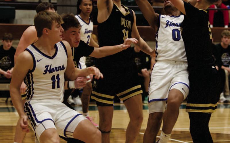 Blocked Tyler Root, #11 and Bryce Loftin, #5, block H-J’s #0 Jackson Seastrunk in Tuesday’s bi-district playoff game in Winnie.