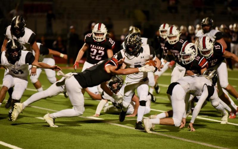 Weston “Seppy” Sepulvado protects the ball as he suits through the Falcon defensive line. Sepulvado had only three carries, but averaged more than 10 yards per carry. Photo by Randall Luker