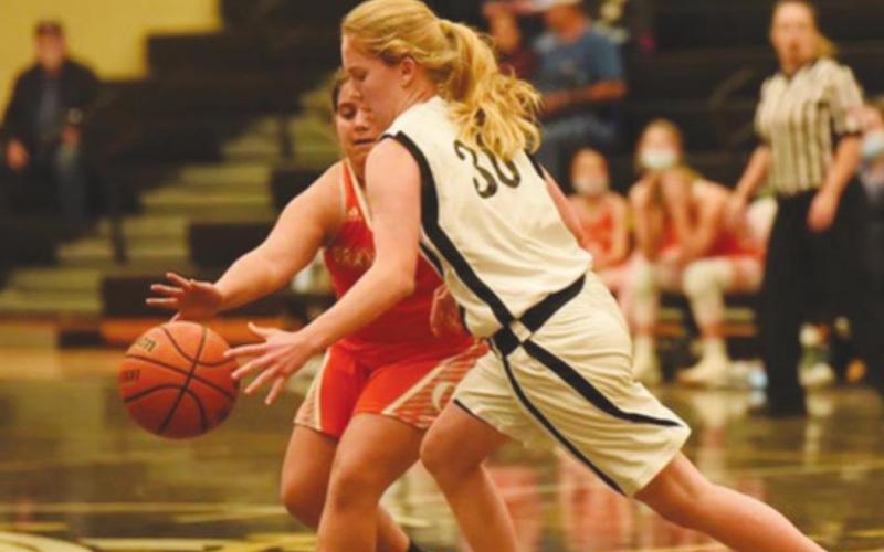 Natalie Hatton dribbles past a Lady Bobcat in the 7th Grade A team game Thursday in Pirate Gym.