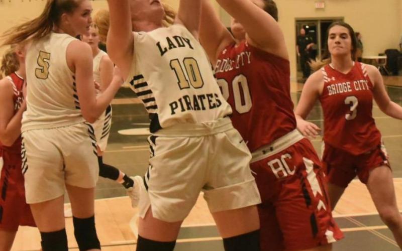 Lady Pirate #10 Natalie Morrison is fouled as she shoots in Friday’s home game versus Bridge City. Also pictured is #5 Raegan Stephenson. Photo by Randall Luker
