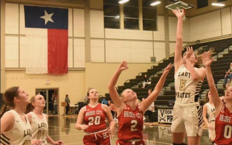 Raegan Stephenson sinks a two pointer as Bridge City defenders try to block. Photo by Randall Luker