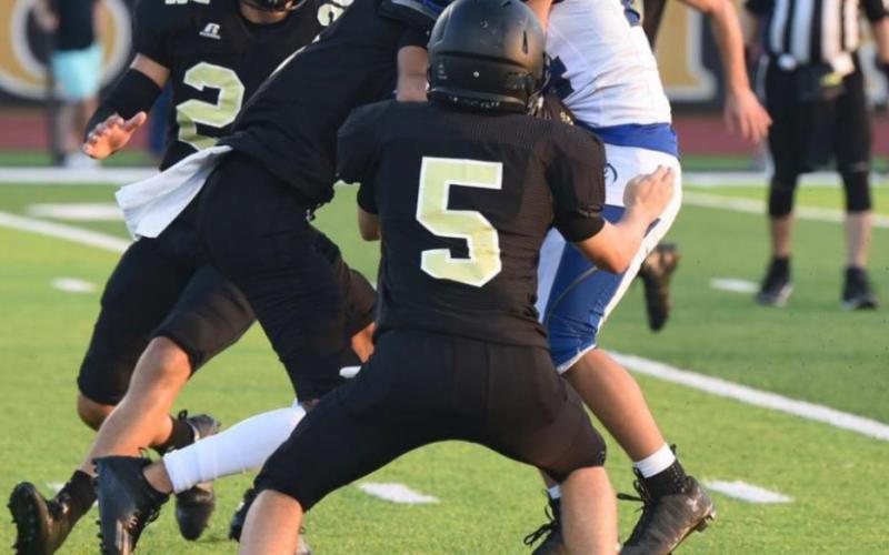 A trio of Pirate defenders stop a Buna ball carrier in Friday’s scrimmage in Vidor. Photo by Randall Luker