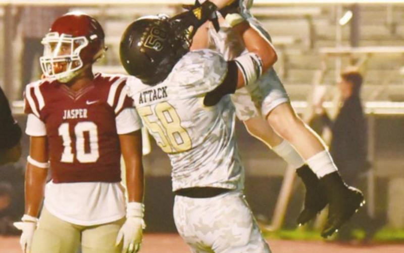 Caiden Veazey hoists Weston Sepulvado into the air after he scored a second half touchdown.