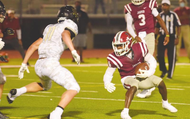 Ty Vincent stands in the way of the Jasper ball carrier.