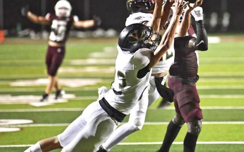 Jett Brucia, #12, intercepts a Moshier pass with Shay Stacy, #23, backing him up.