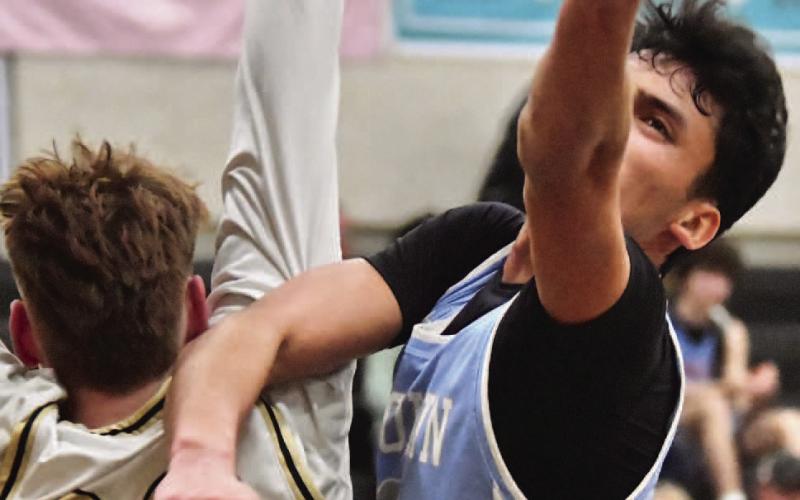 Colton Callahan defends under the basket.