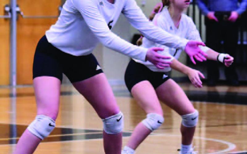 Varsity Lady Pirates Madison Powell, left, and Mia Robin await a Silsbee Lady Tiger serve Friday. Photo by Randall Luker