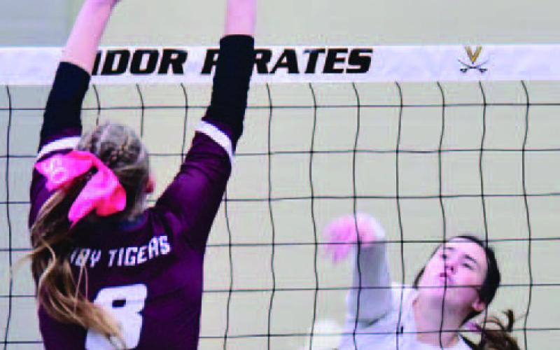 Brilie Cornelison hits a hard return past a Lady Tiger Friday at Pirate Gym. Photo by Randall Luker