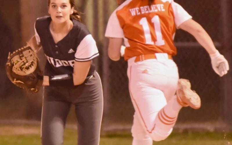 An Orangefiled runner couldn’t beat the throw to first baseman Brooklyn Bushelle in Friday’s district game in Orangefield. Photo by Randall Luker