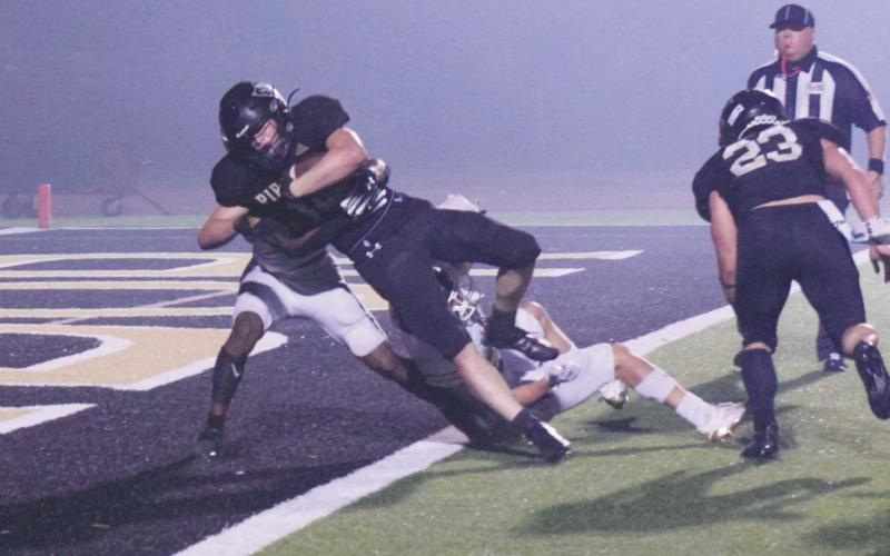 Pirate RB Jason Watson caps a 10-yard run with a touchdown in fourth quarter action Friday.
