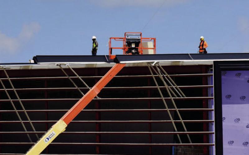 Contractors brave the sweltering heat to install the metal roofing on the Vidor Middle School Monday. Some of the rooftop HVAC units have been placed on previously completed areas of the structure. VISD Superintendent Dr. Jay Killgo said he receives construction updates weekly. “Things seem to be moving along well on the project and we are hoping for a mid-year move in.'
