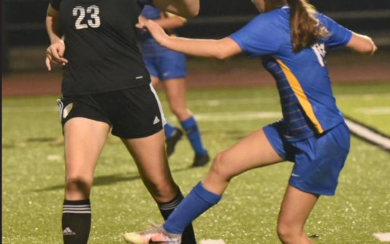 VHS junior Alaina Davis battles for ball control in last weeks scrimmage with Kelly. Photo by Randall Luker