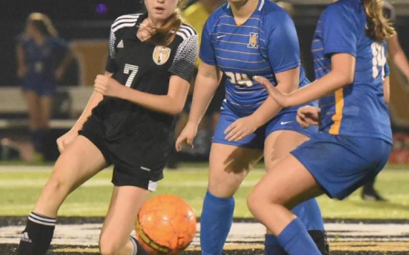 Freshman Lady Pirate Chloe Post looks to pass the ball to an open teammate. Photo by Randall Luker