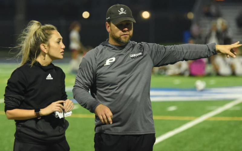 Head Coach Ralph Fields and assistant coach Ciera Tinkle discuss the game at the half. Photo by Randall Luker