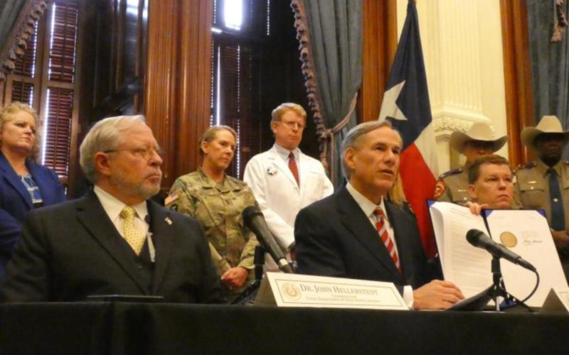 David Fleeger, MD, (in white coat) listens as Gov. Greg Abbott declares a state of emergency over COVID-19 in March, 2020. Courtesy Photo