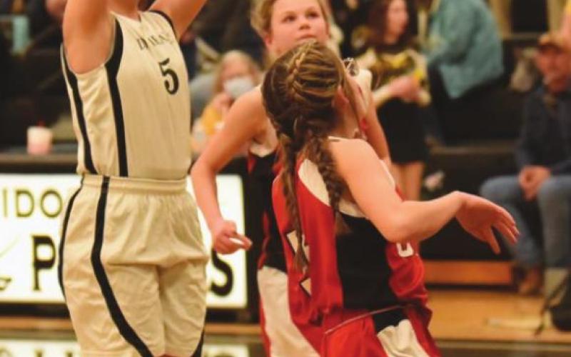 Lady Pirate Cassidy Callarman takes a shot over two Bridge City defenders in the 8B game.