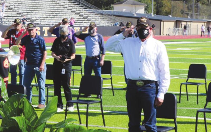 Olivia McWherter played TAPS while veterans saluted.