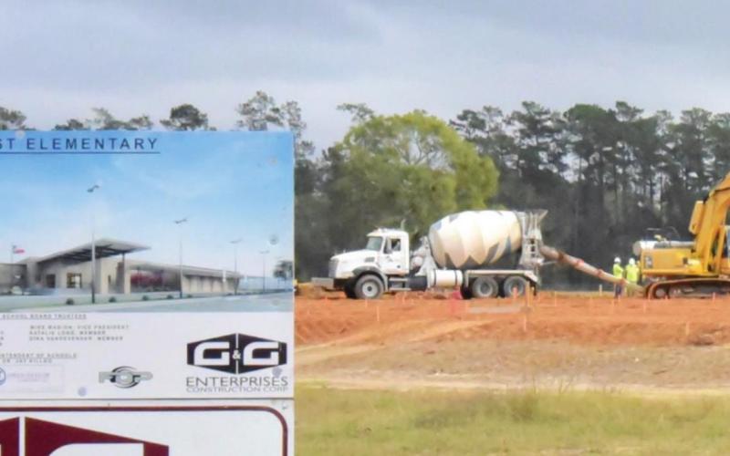 Workers are drilling and pouring foundation anchors as construction continues on the new Oak Forest Elementary School on Highway 12. An artist’s conception of the finished product may be seen on the sign in the lower left of the photo.