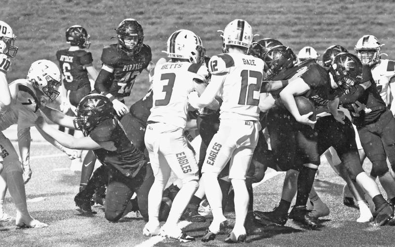 Bustin’ loose Pirate fullback Riley Marlow breaks through the crowd at the goal line to score for the Pirates.