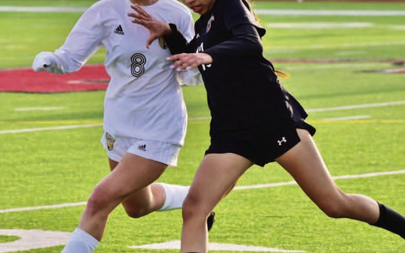 Natalie Domec closes in on a Jasper player in Friday’s away game at Jasper. Photo by Randall Luker