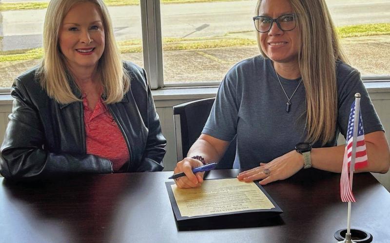 Pictured is Mayor Misty Songe presenting CTE Director Penny Singleton with a signed Proclamation Document.