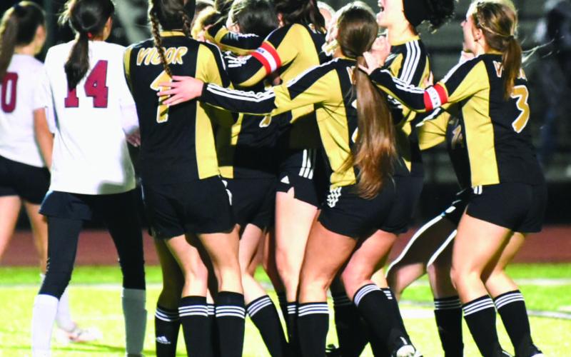 Teammates swarm Chloe Post after she scored in OT to give Vidor the district win over Jasper. Photo by Randall Luker