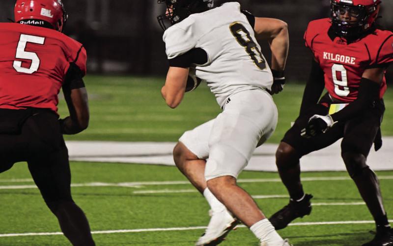 Dallas Pachuca finds a little running room between two Bulldog defenders to pick up a first down Friday at Kilgore.