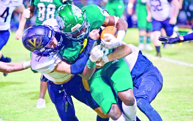 Pirate defenders Blake Richards and Bryce Dubose team up to bring down a Livingston runner Friday at Livingston.