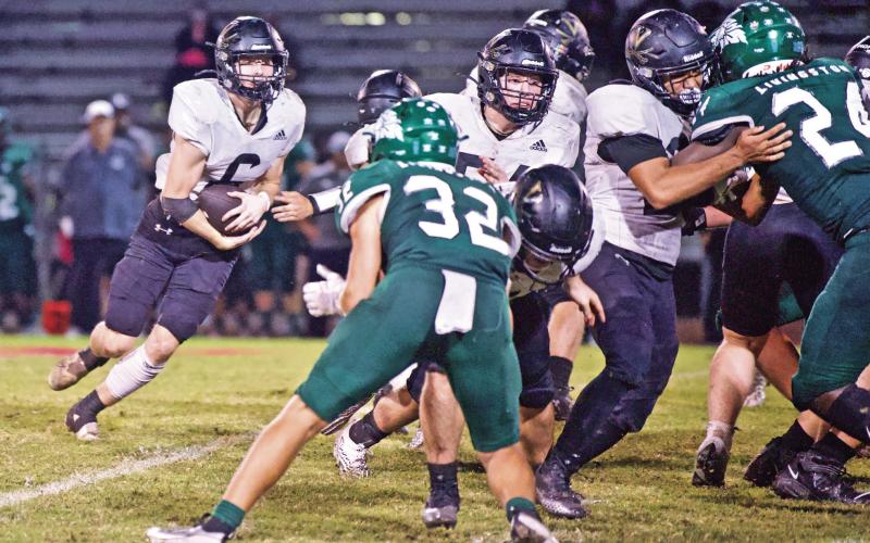 Vidor RB Dane Villadsen follows his blockers through the Livingston Lion defensive line in Friday’s 31-21 district win.